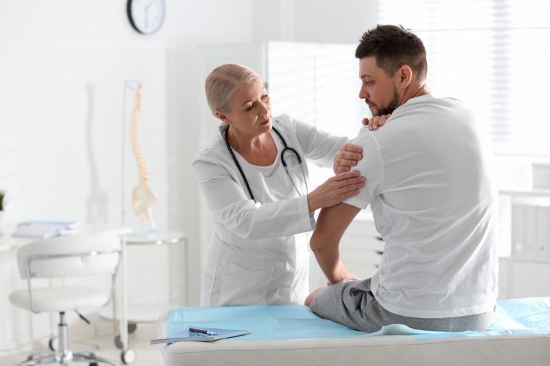 An orthopedic provider examining a patient in clinic